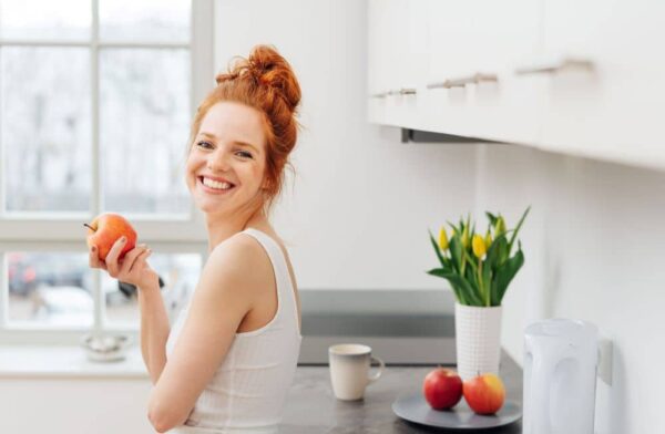 Woman eating fresh apple.